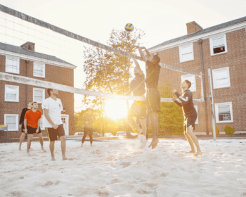 Students playing volleyball outside