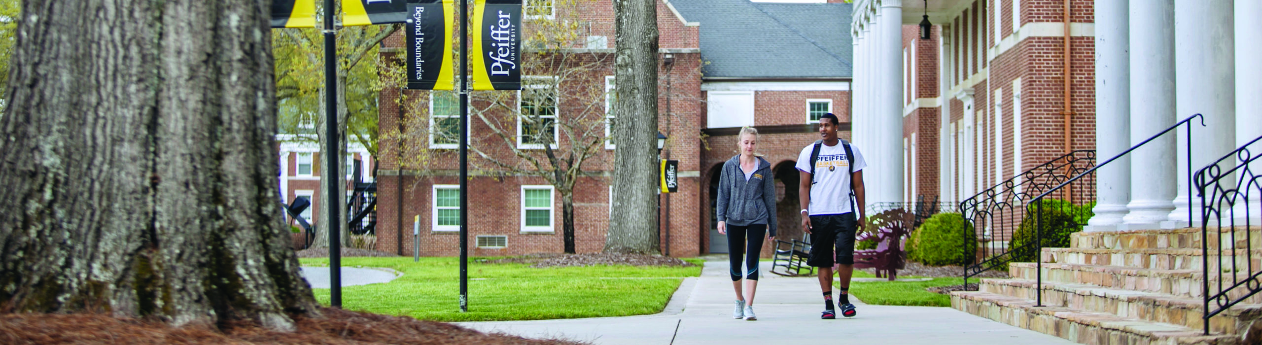 two students walking outside on campus